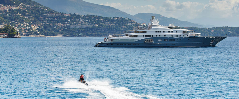 passes behind a boat